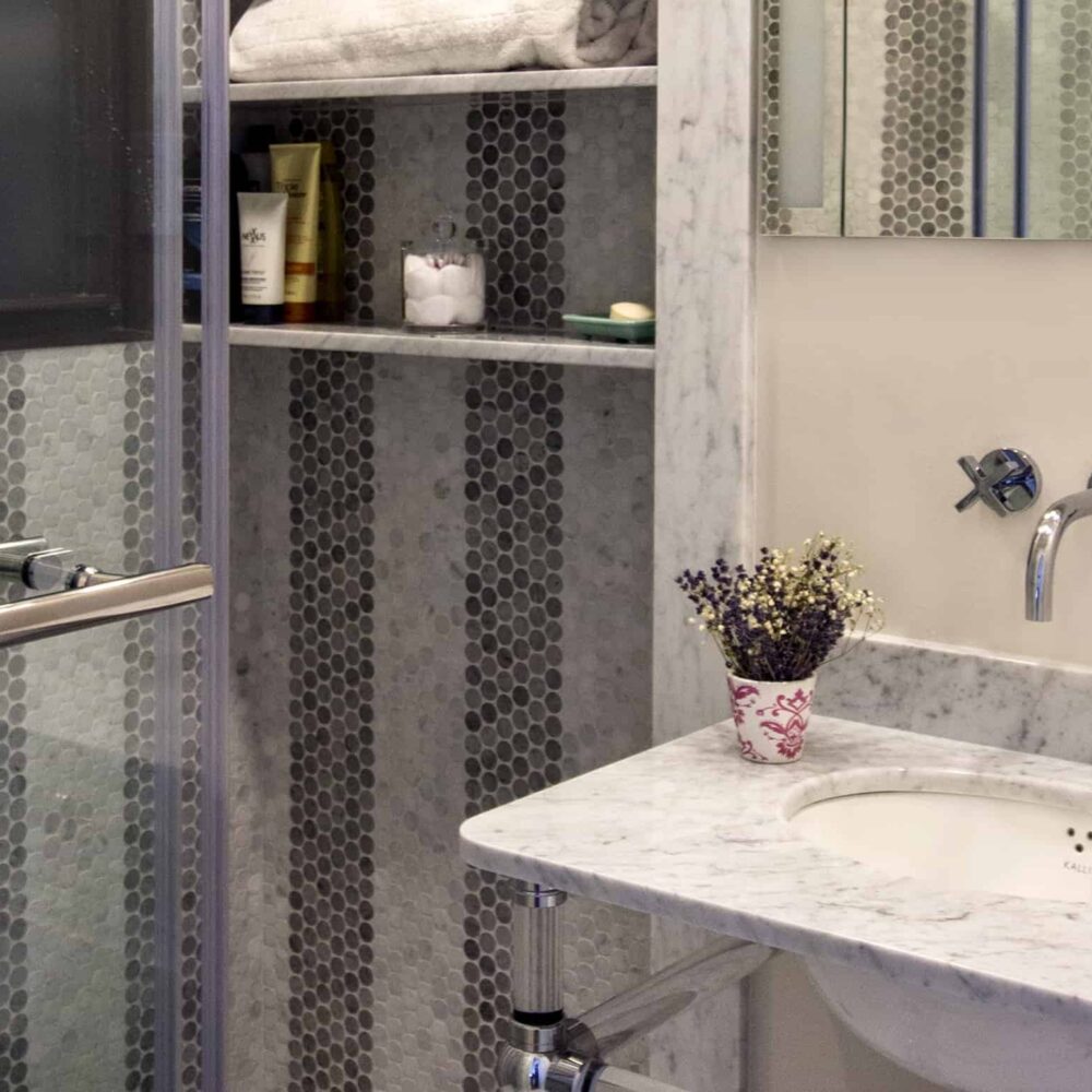 Bathtub installation in NYC bathroom renovation with high-end finishes by Gurri Remodel